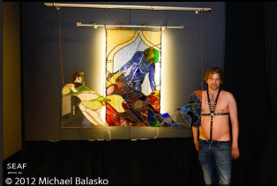 princeHerman standing in front of large stained glass piece